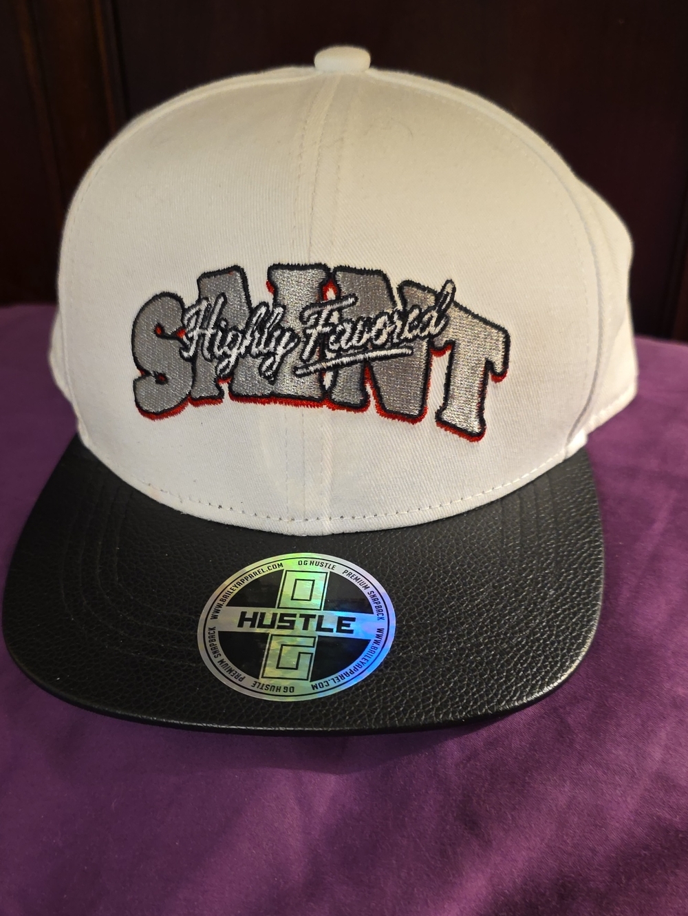 White and Black Cap with 'Highly Favored' Graphic